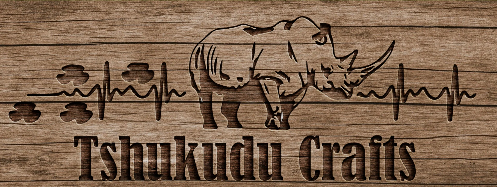 Tshukudu Crafts wood banner featuring the rhinoceros design and company name